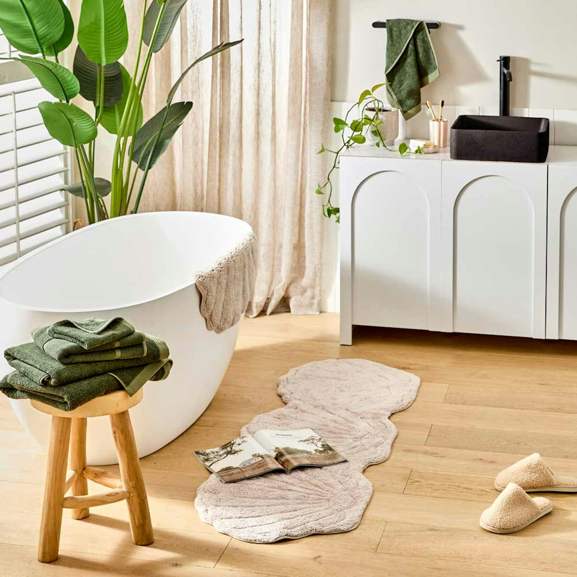 white bathroom with green bath towels - gift ideas for her