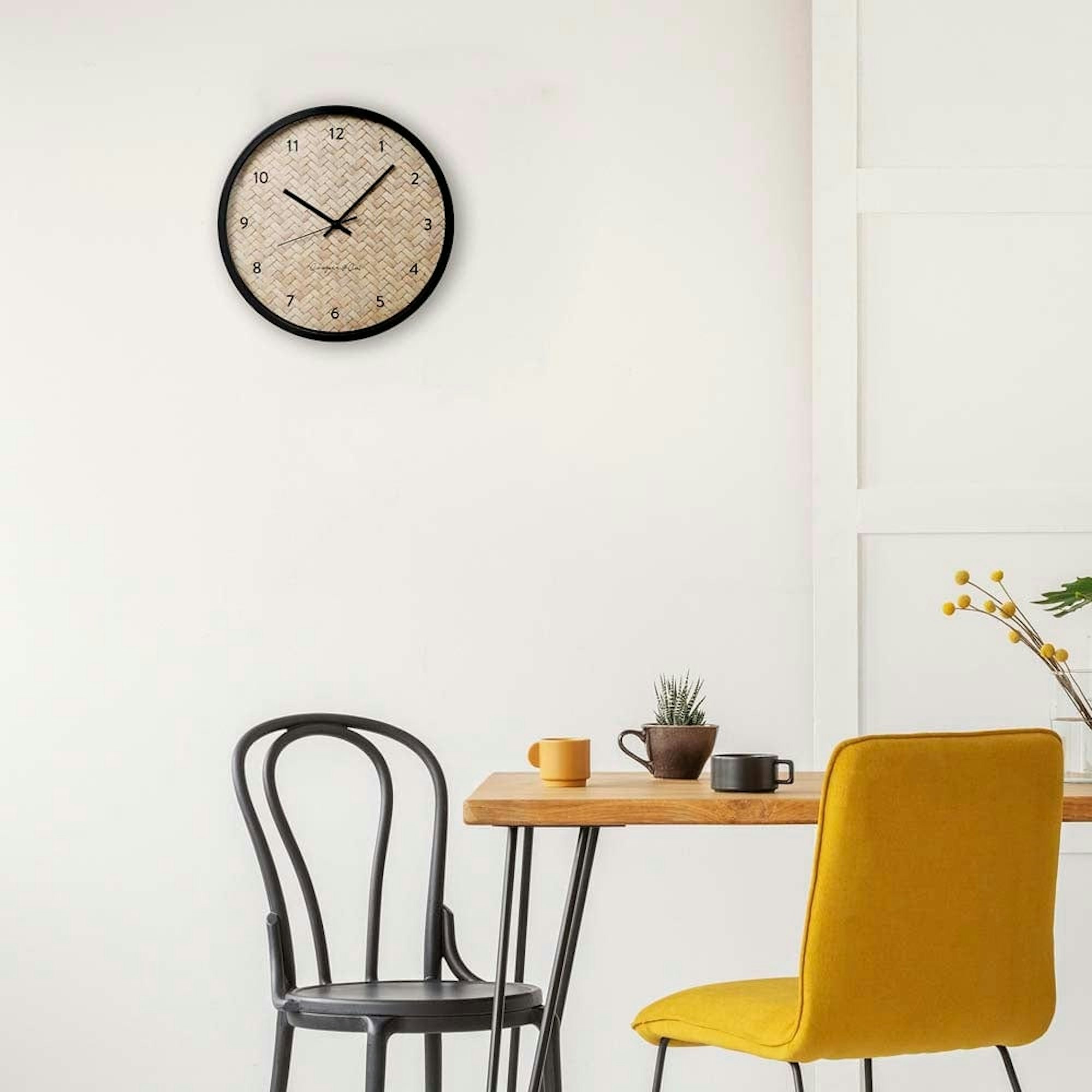 Kitchen dining setting with mix and match chairs, home decor and wall clock. Scandinavian style setting.