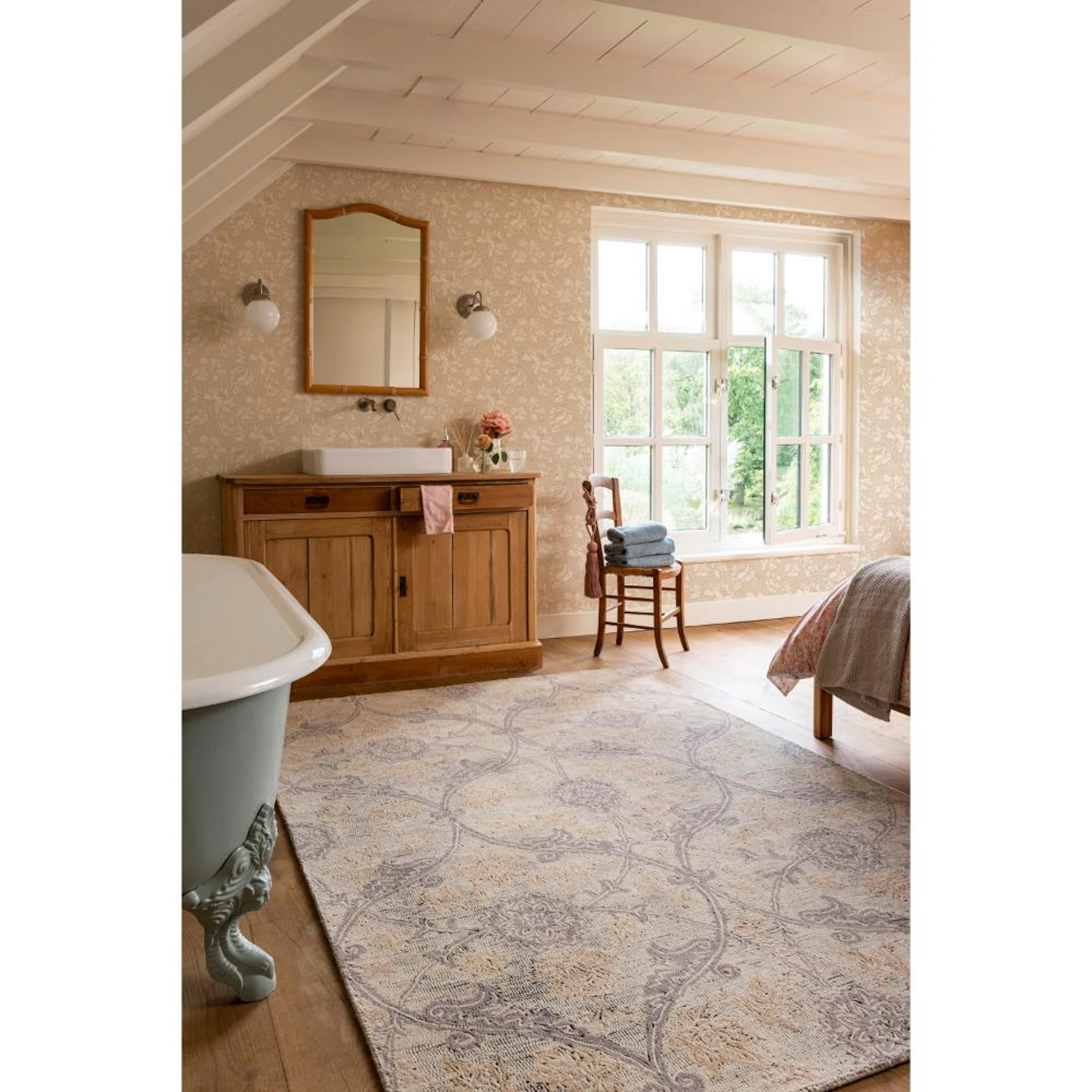 Laura Ashley Endale Soft Truffle rug styled in a bedroom with an elegant intertwining damask pattern in soft neutral truffle tones