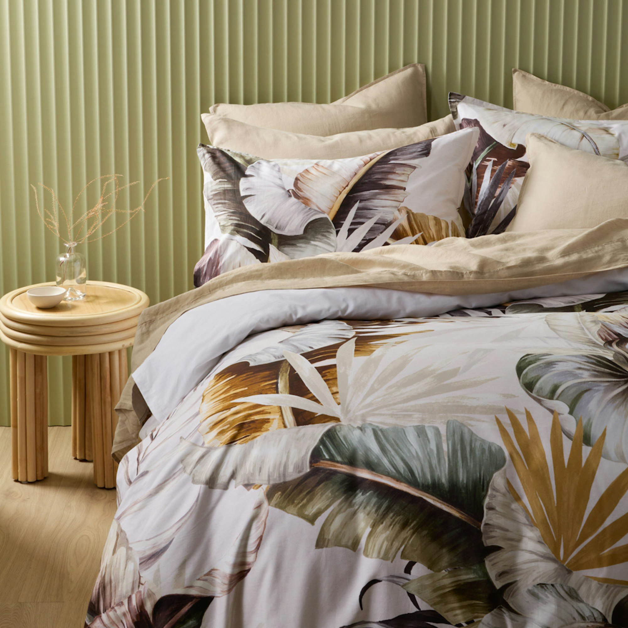 Complete bedroom setting with palm leaf quilt cover and green ribbed walls