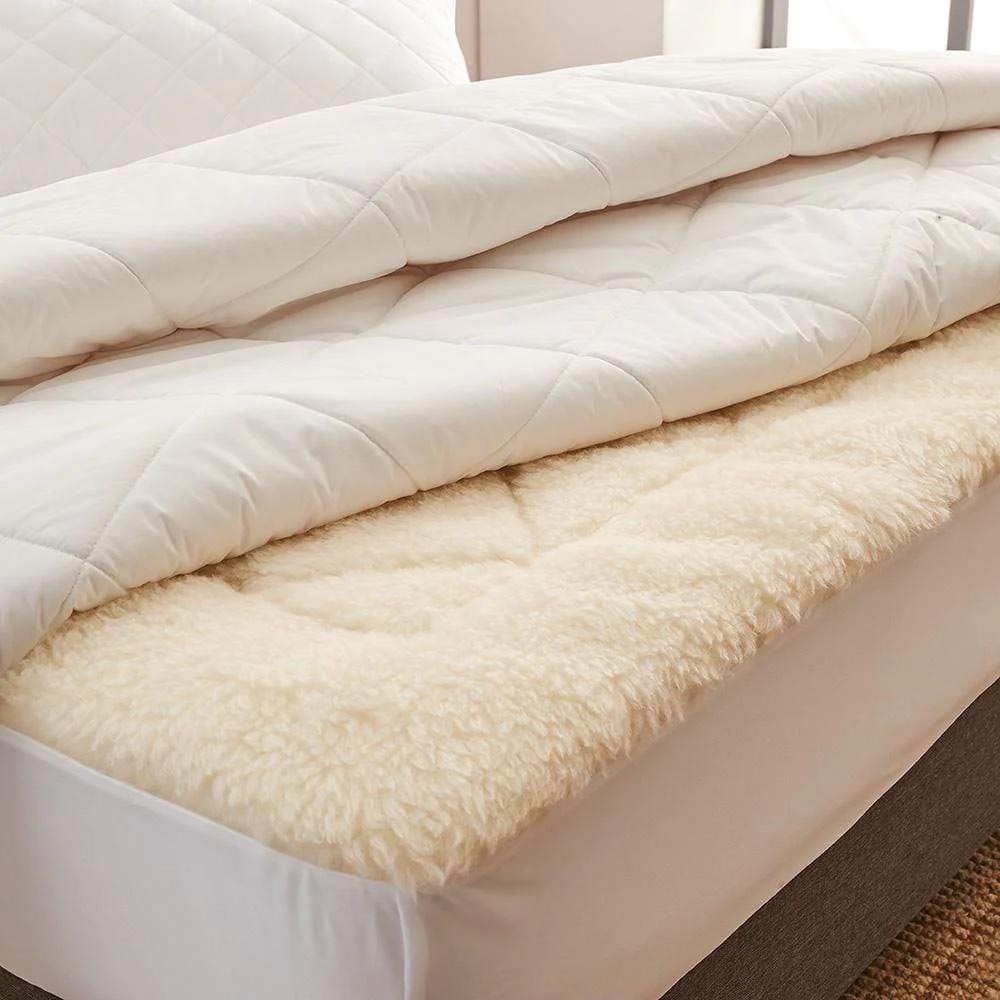 MyHouse Luxe Wool 300 Quilt folded back on a bed, featuring a quilted cotton cover layered over a plush wool underlay in a neutral bedroom setting