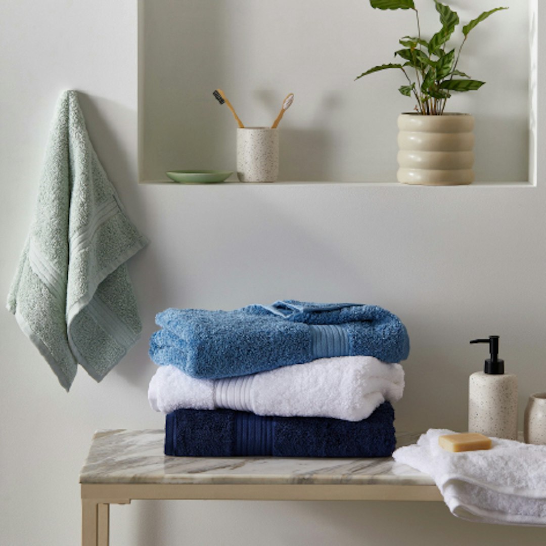 bathroom showing towels stacked on top of each other