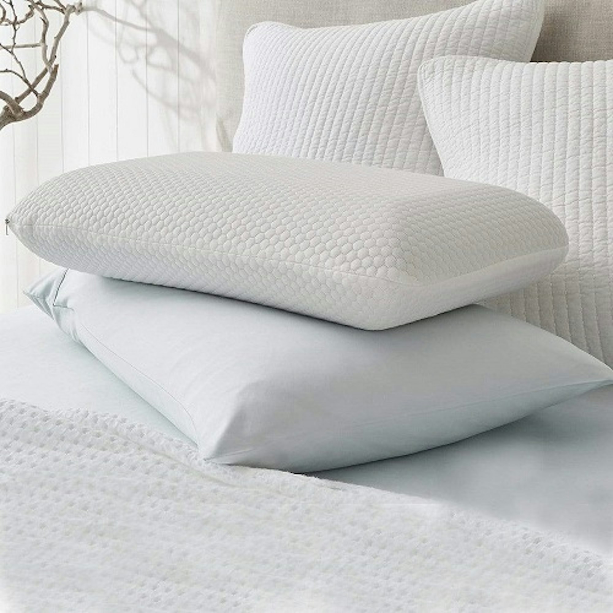 Bedroom pillows stacked on top of a bed