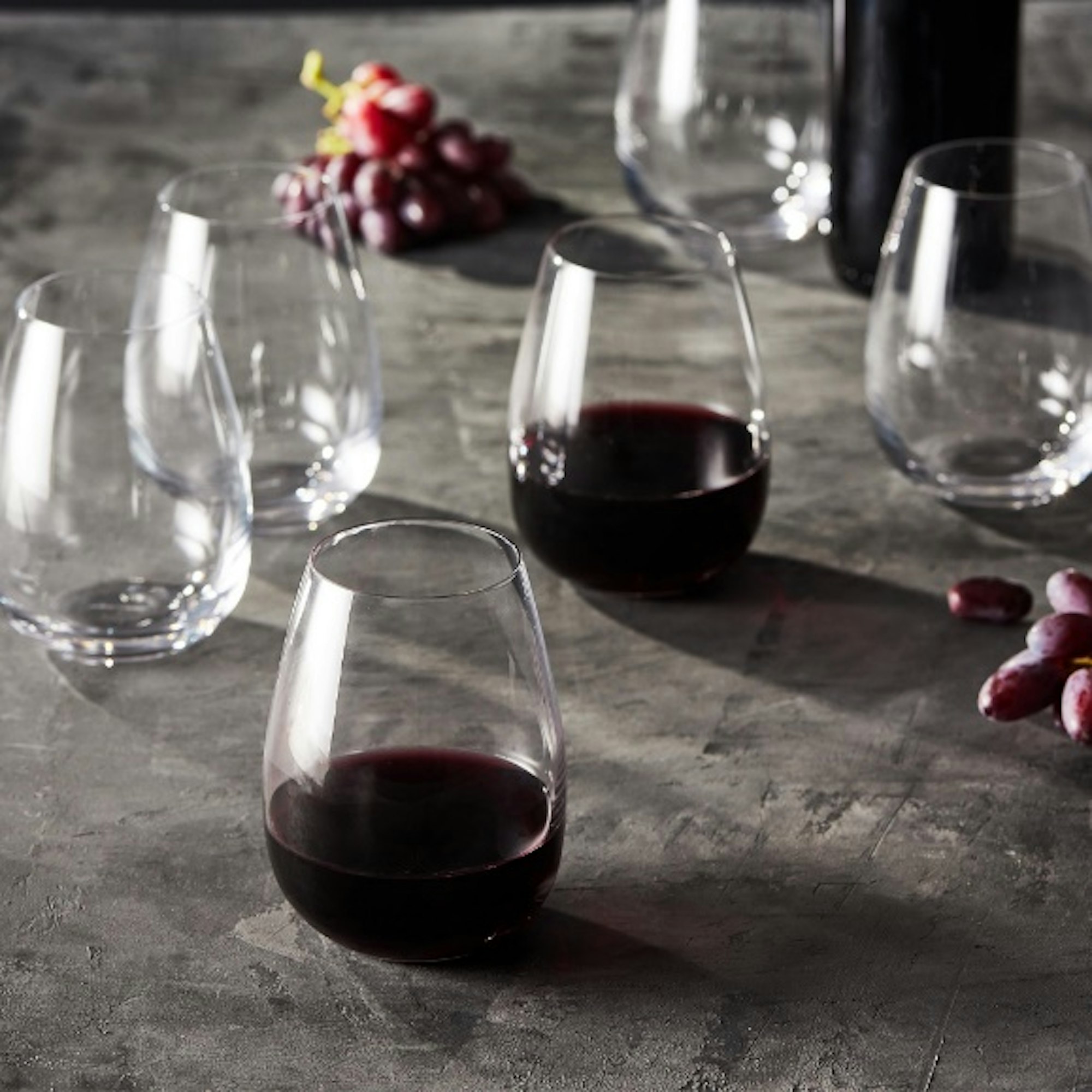 stemless wine glasses filled with red wine