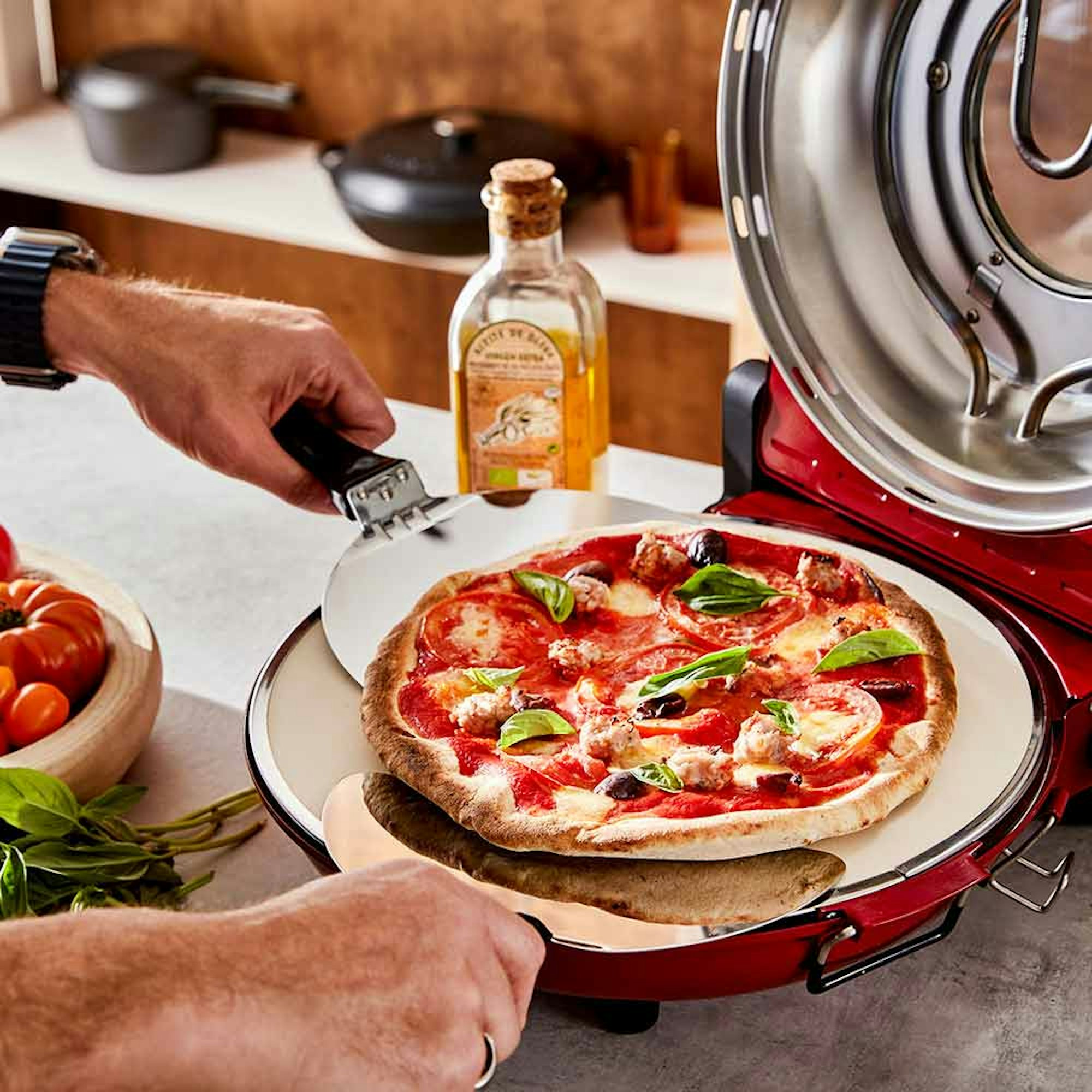 How do you slide pizza onto a hot pizza stone? man lifting pizza from a pizza oven