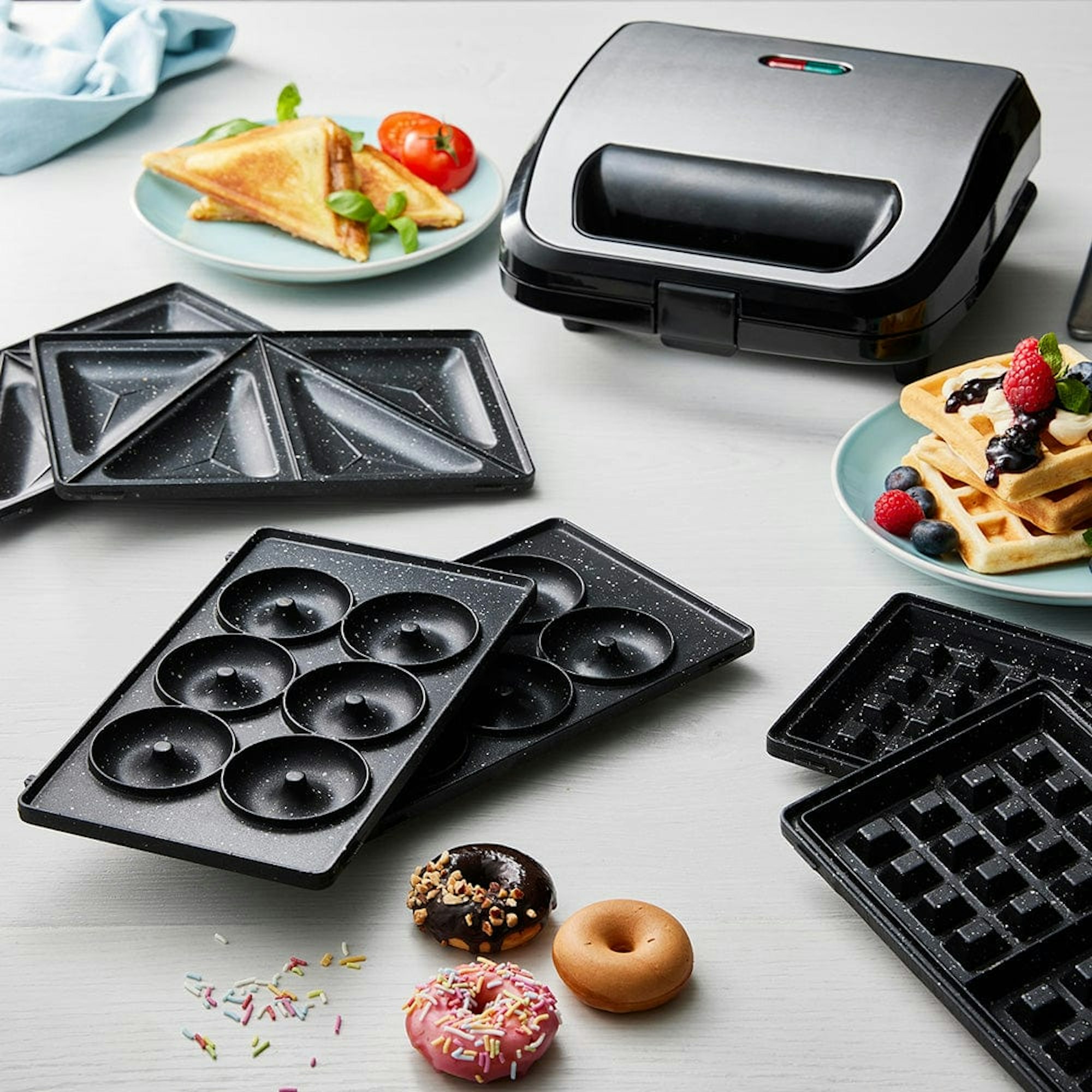 waffle press with various attachments on a kitchen benchtop