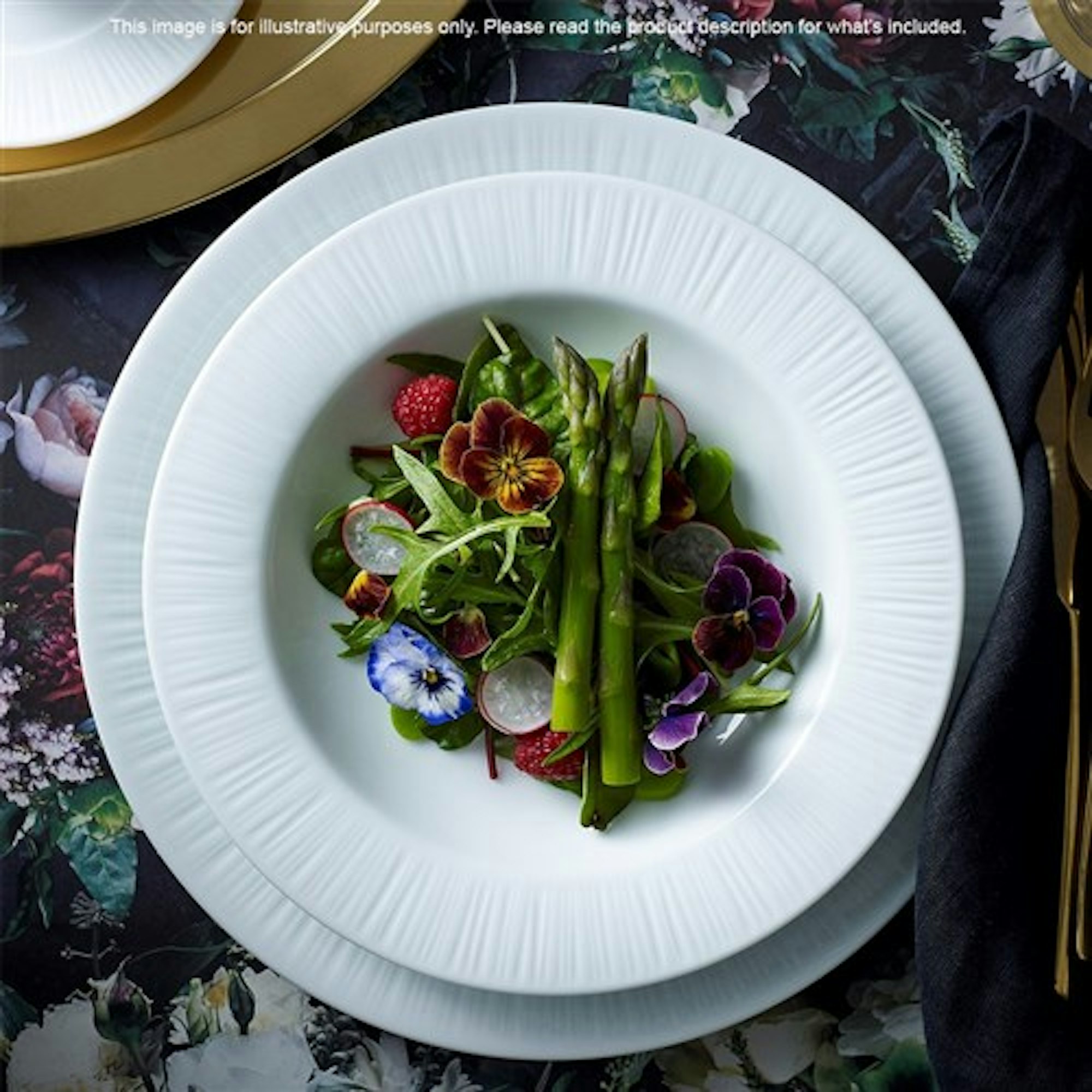 white dinner set serving spring salad with dark floral tablecloth