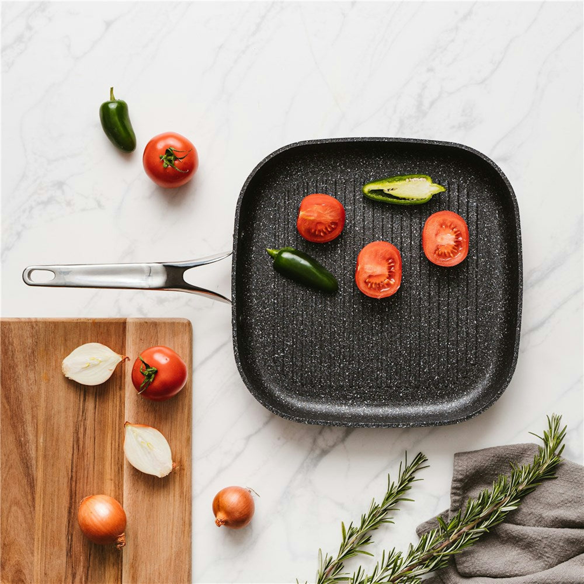 Father's day gift guide. Grill pan with vegetables on a marble countertop