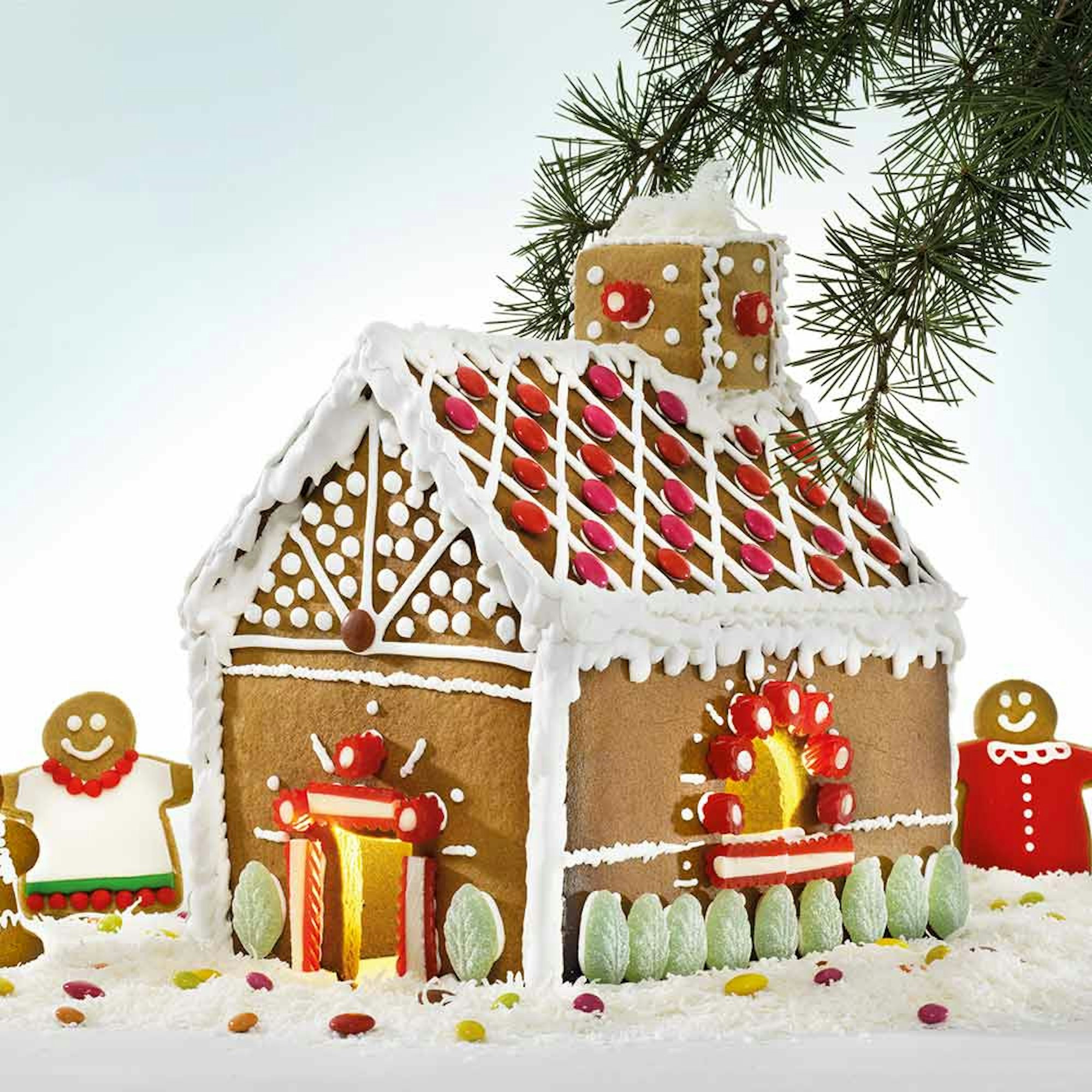 Gingerbread House recipe Robins Kitchen blog. Gingerbread house with gingerbread people decorated with icing, lollies, and coconut.