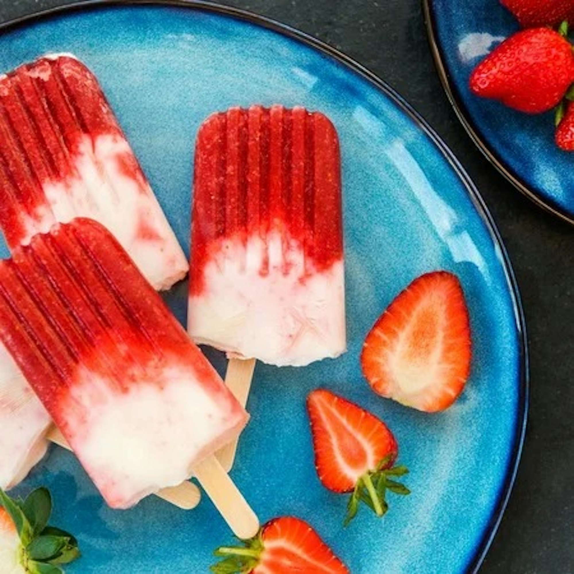 How to make icy poles? How to make summer desserts? Robins kitchen blog. strawberry and vanilla ice blocks on a blue plate.