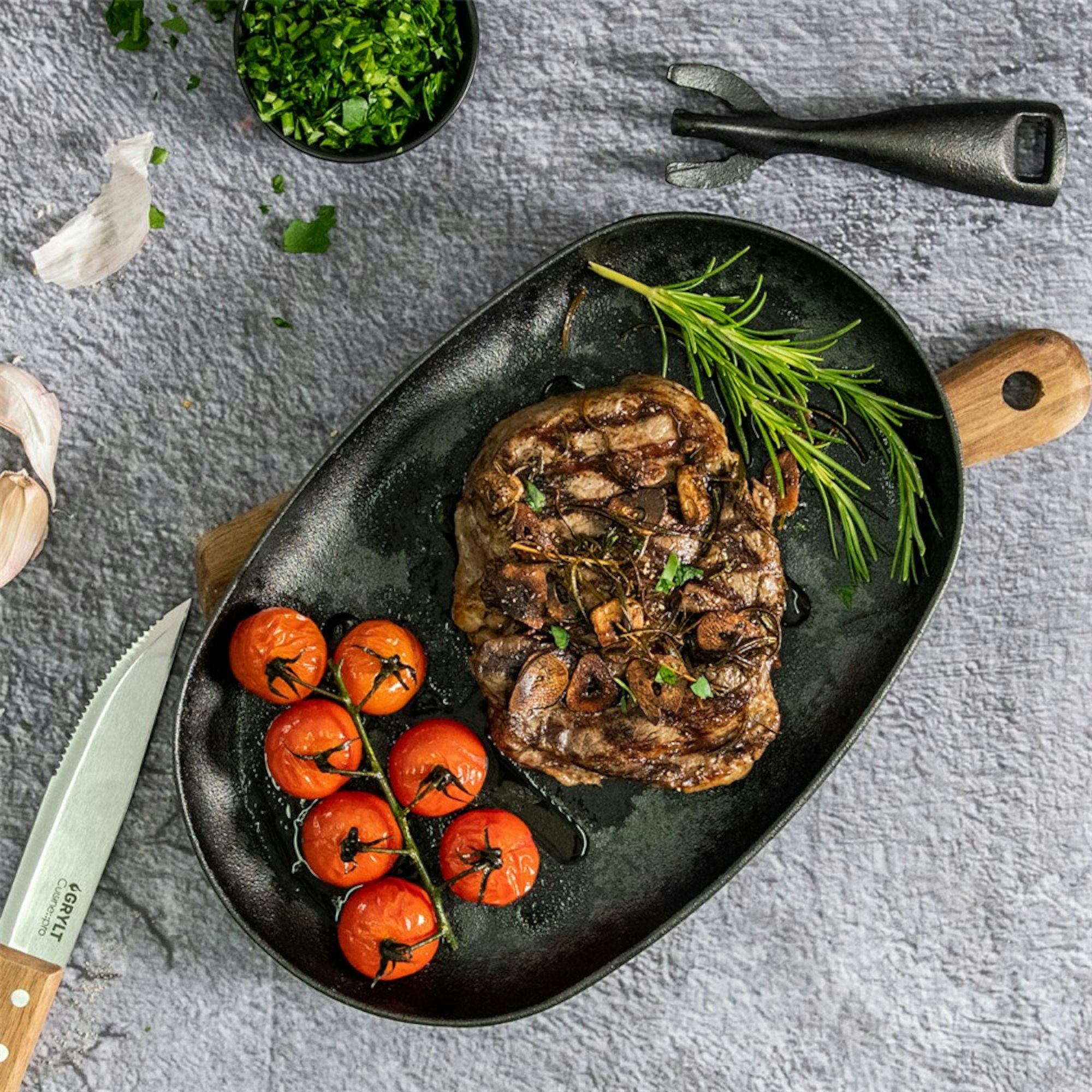grill char marks reverse seared steak in skillet with tomatoes