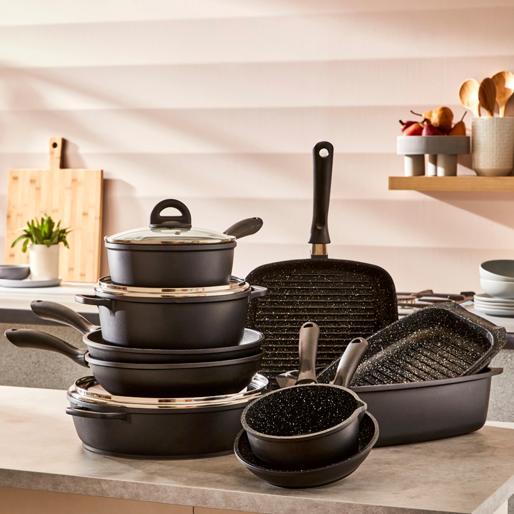 Baccarat STONE 10 Piece Cookware Set with wok, featuring non-stick saucepans, frying pans, grill pans and roasting dishes arranged on a kitchen countertop