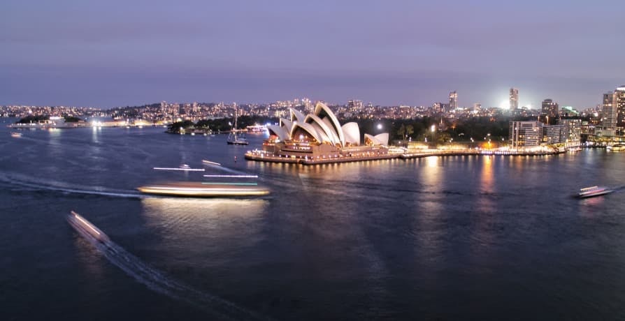 view of sydney opera house on water at dusk