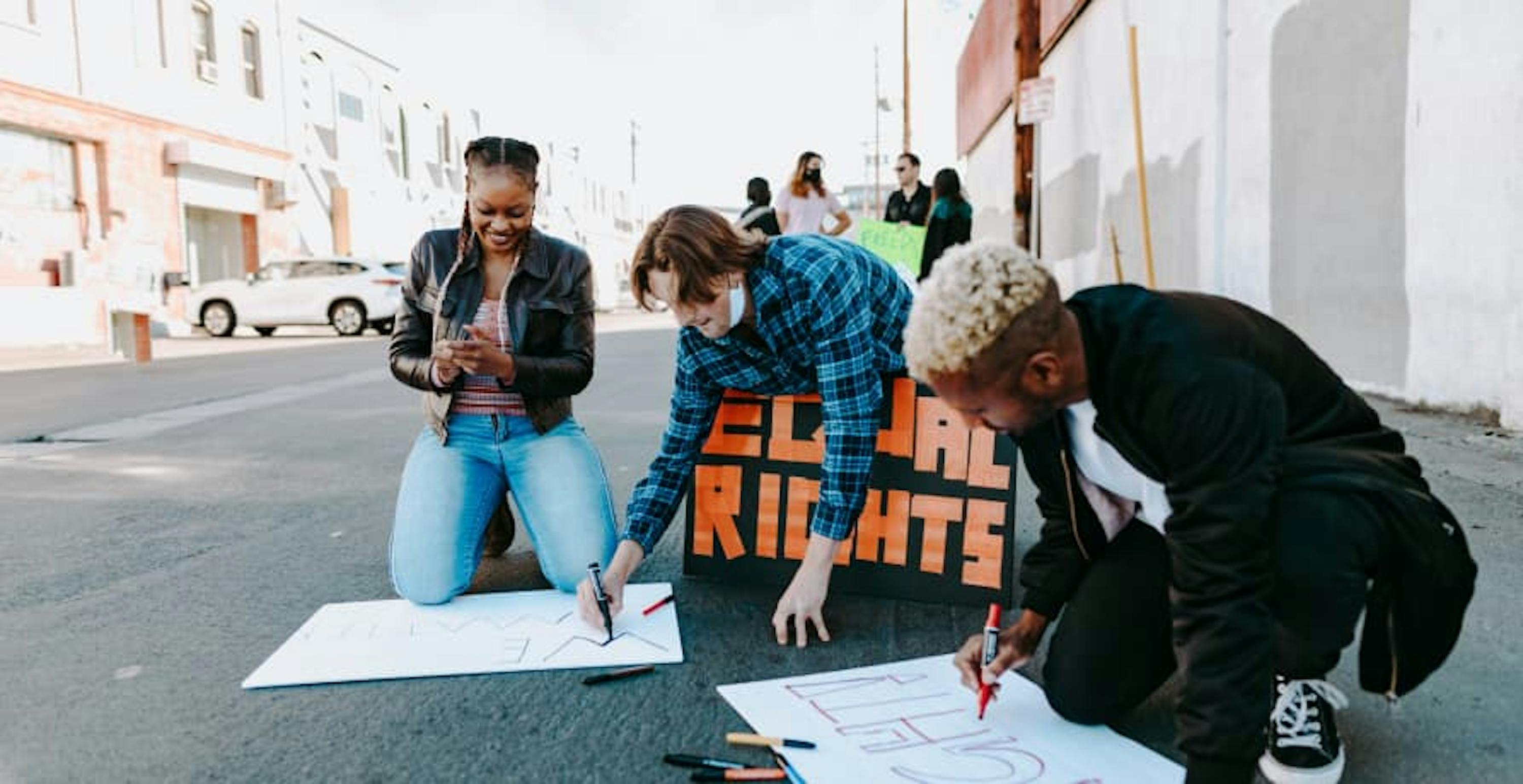 teenagers making protest signs 