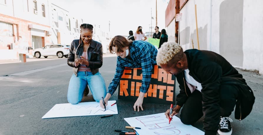 teenagers making protest signs