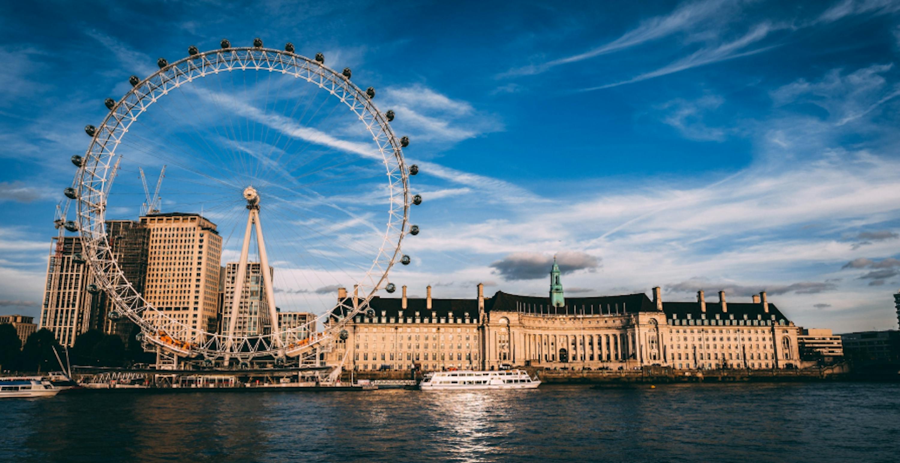 London Eye next to the Thames river