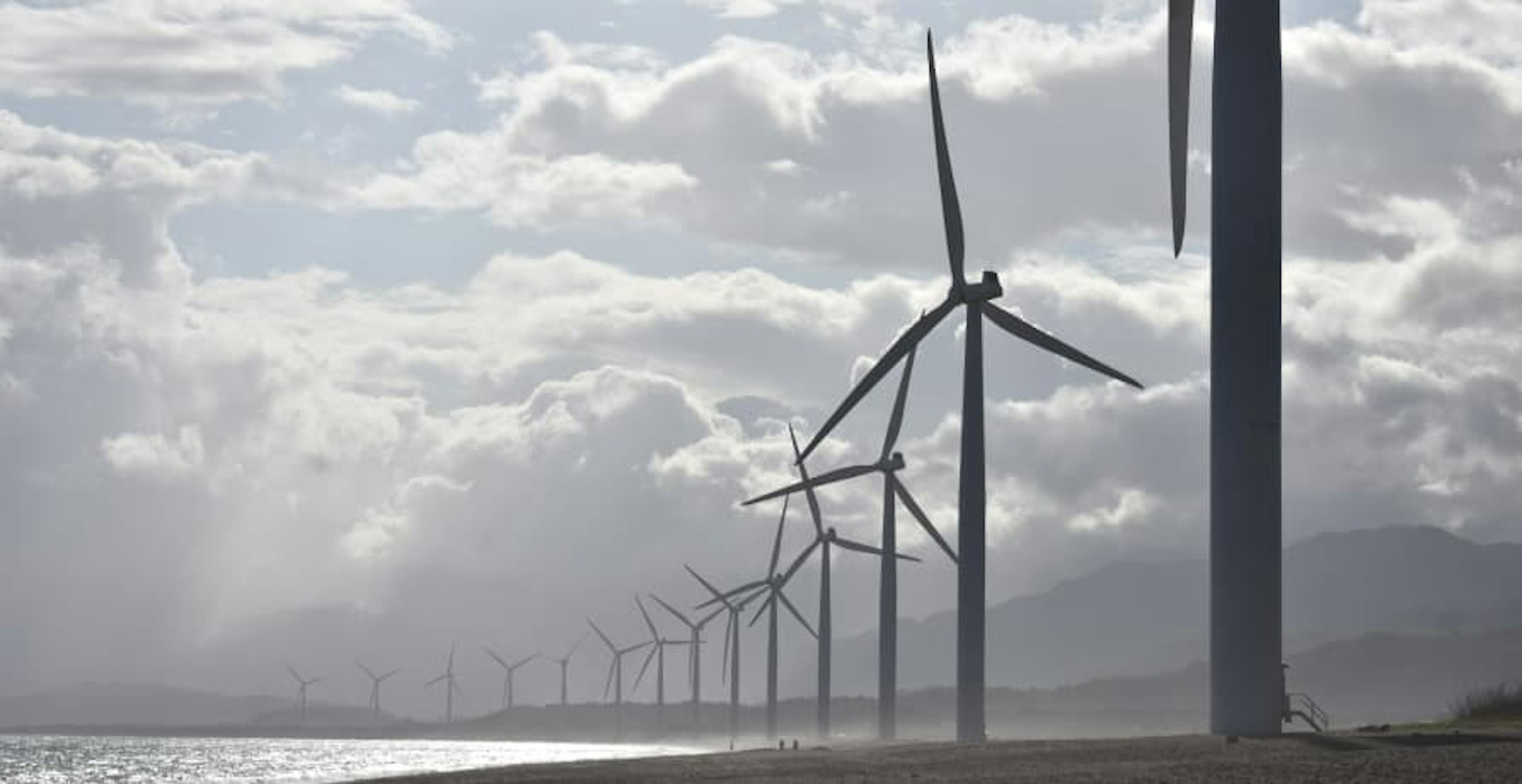 wind farm against a cloudy sky