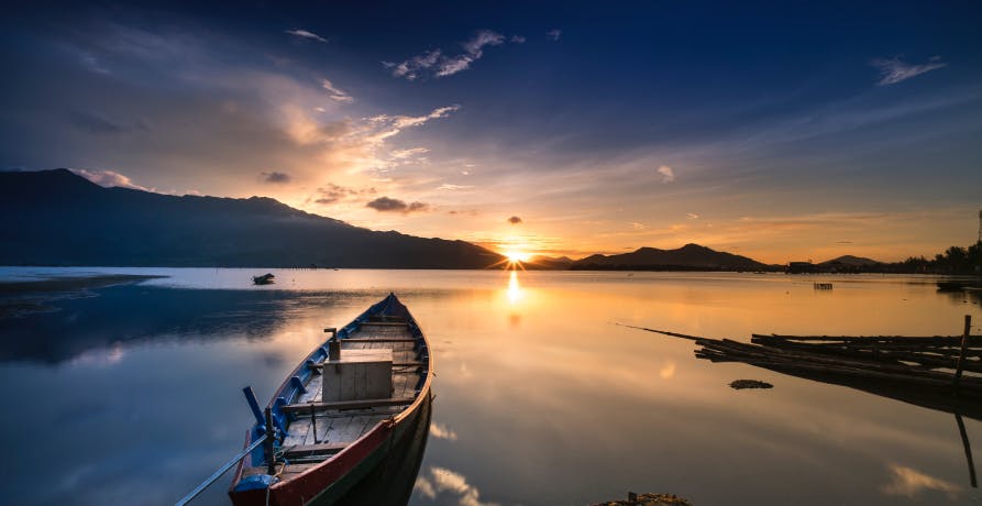 View of boat on water in sunset