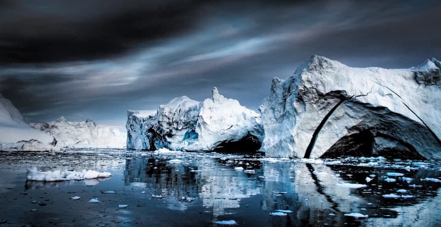 ice caps melting under dark sky