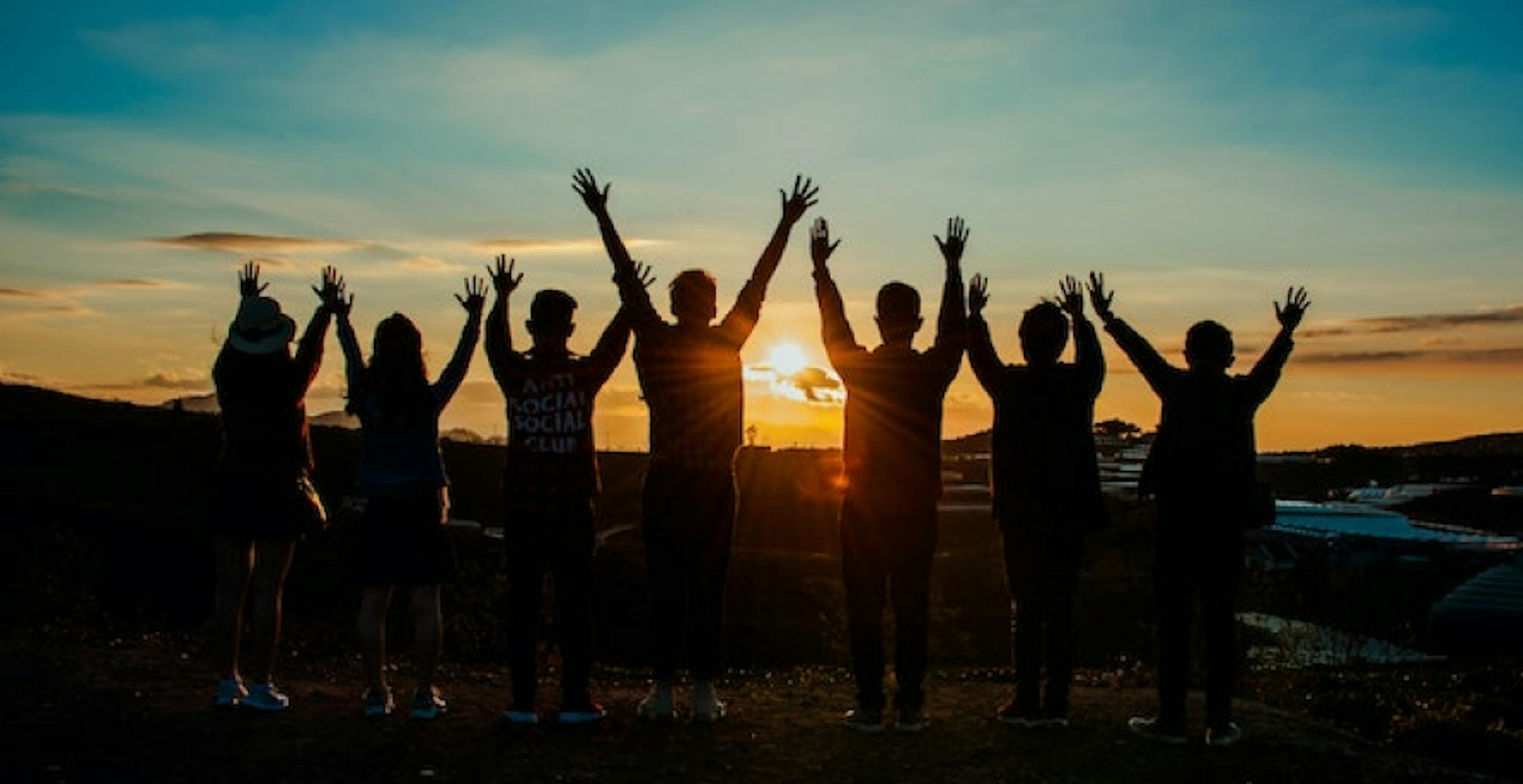 people looking at the sunset