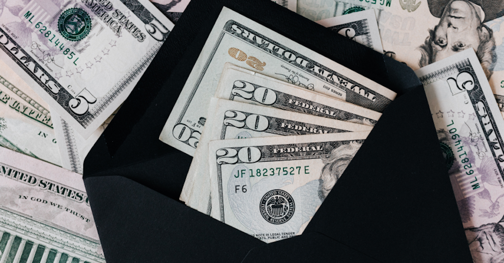 black wallet with $20 USD bills