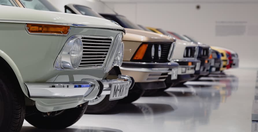 old cars lined up showing hood