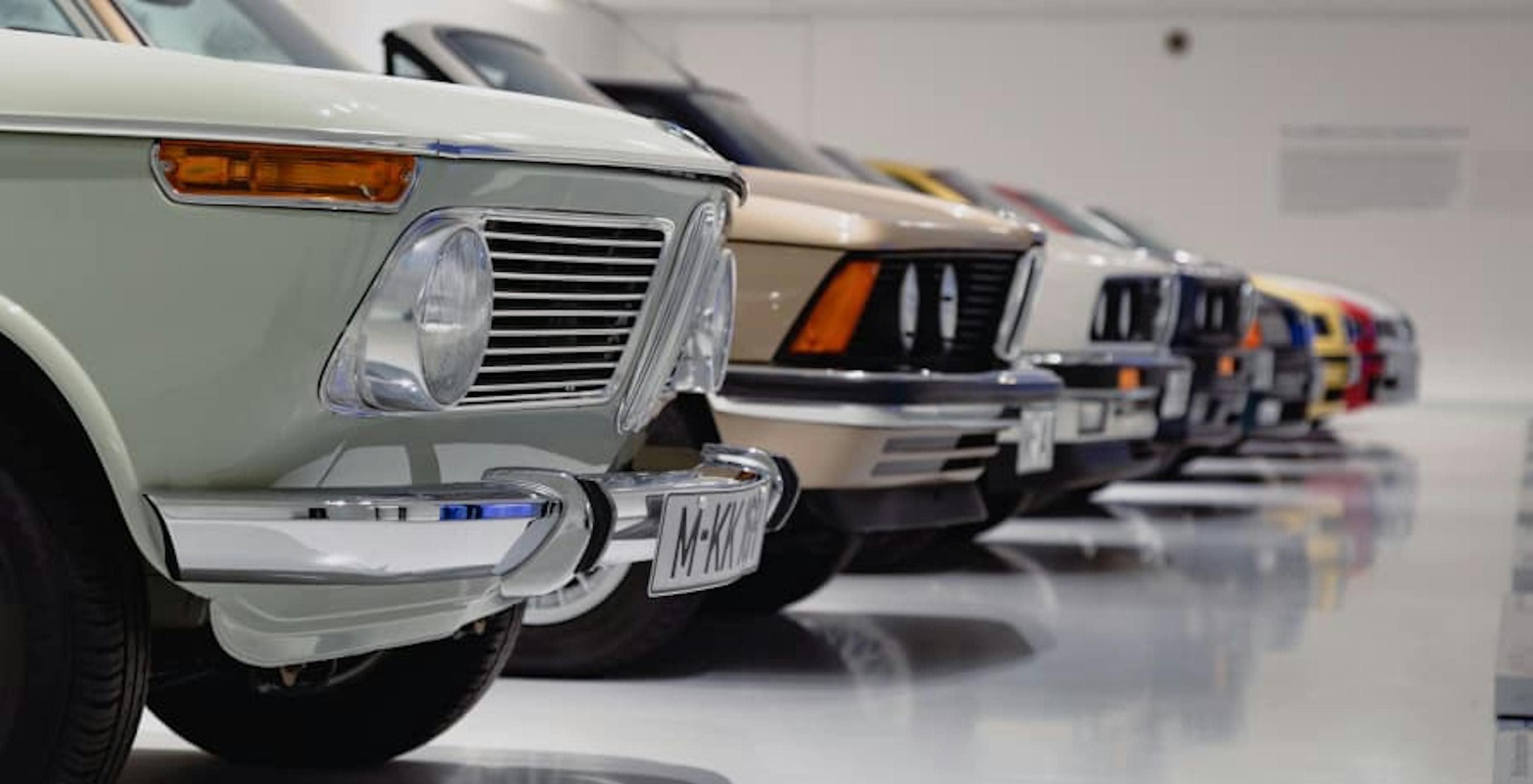 old cars lined up showing hood