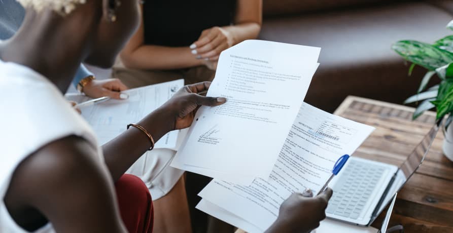 woman looking at work documents at her desk