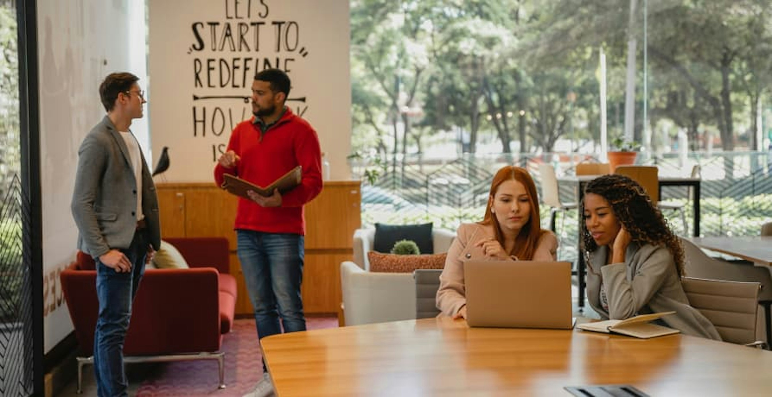 small company meeting in open glass door office