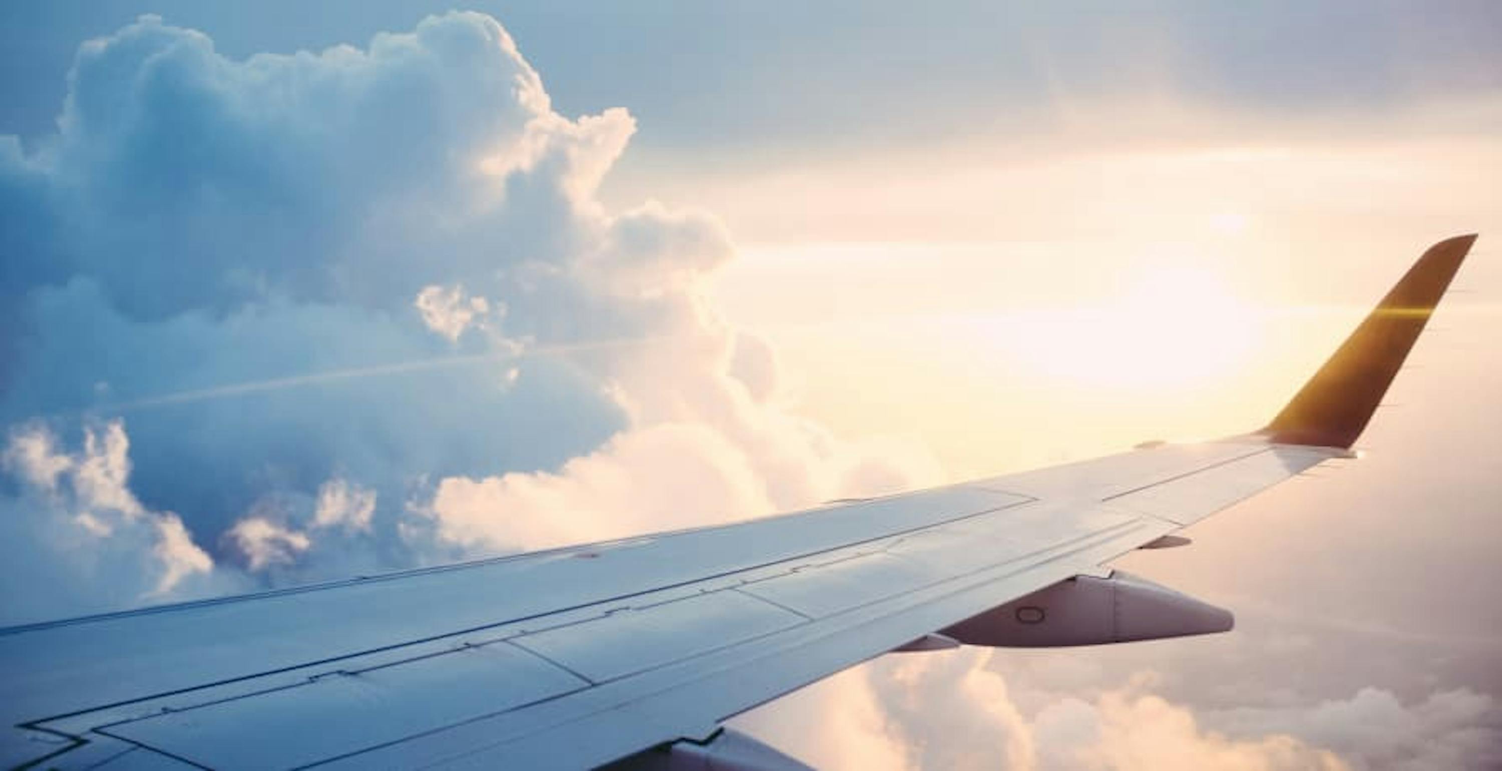 airplane wing with sunrise