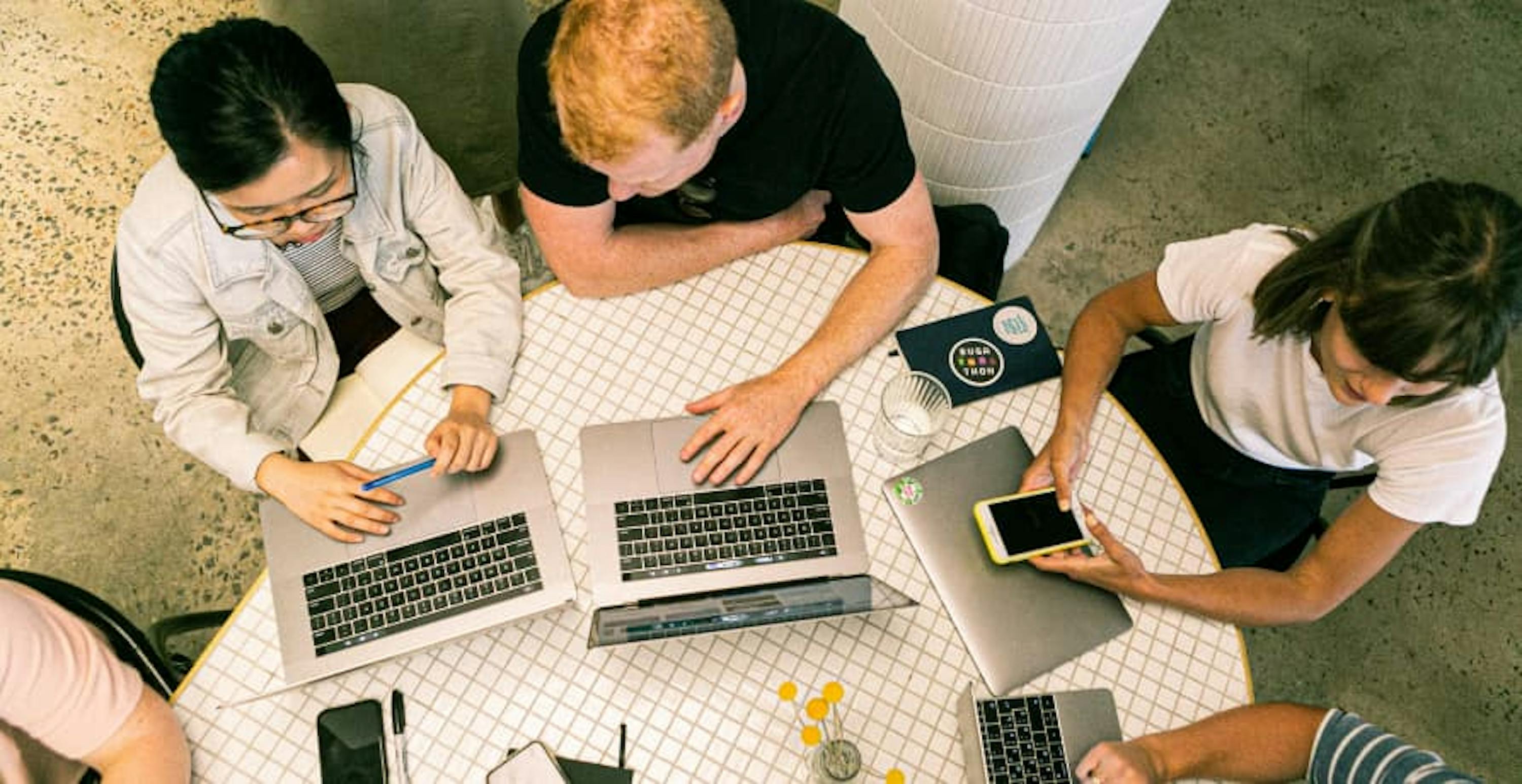 three colleagues sitting and working on their laptops