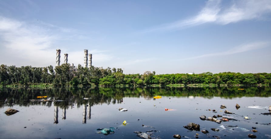 polluted river with lots of plastic floating