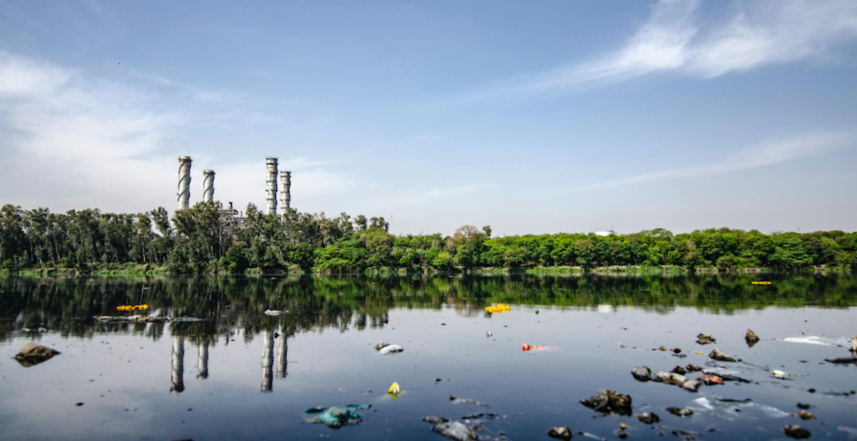 polluted river with lots of plastic floating