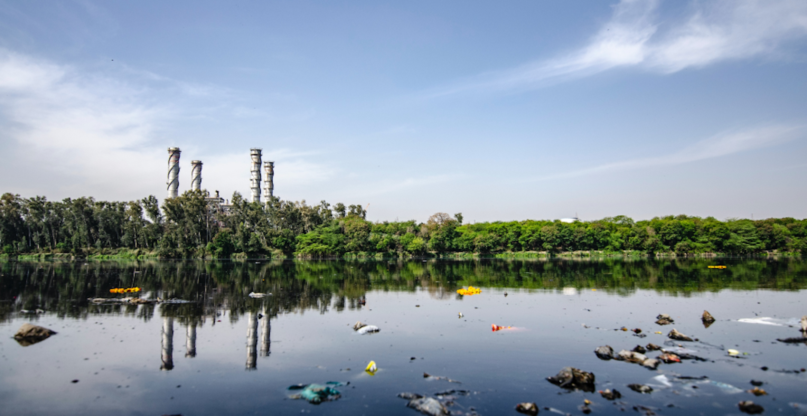 polluted river with lots of plastic floating