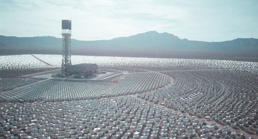 hundreds of solar panels and mountains