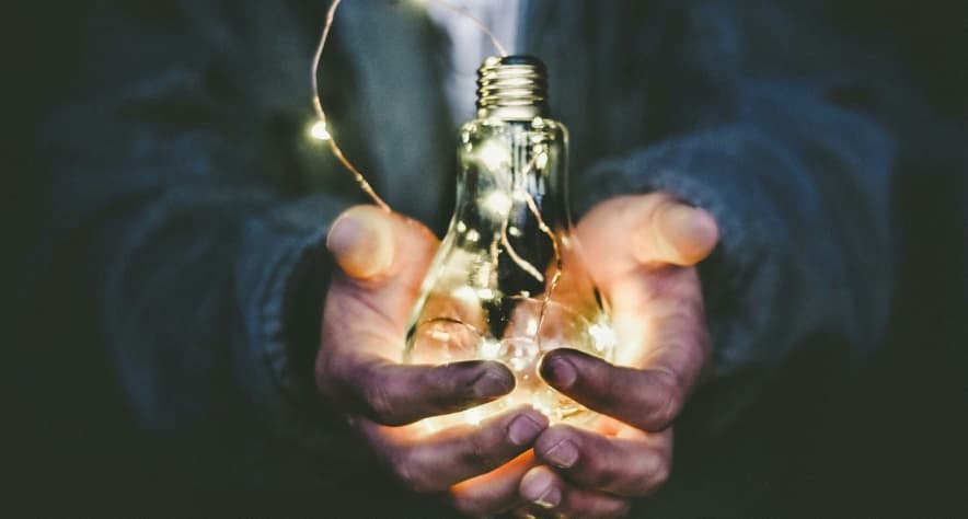 person holding a lightbulb