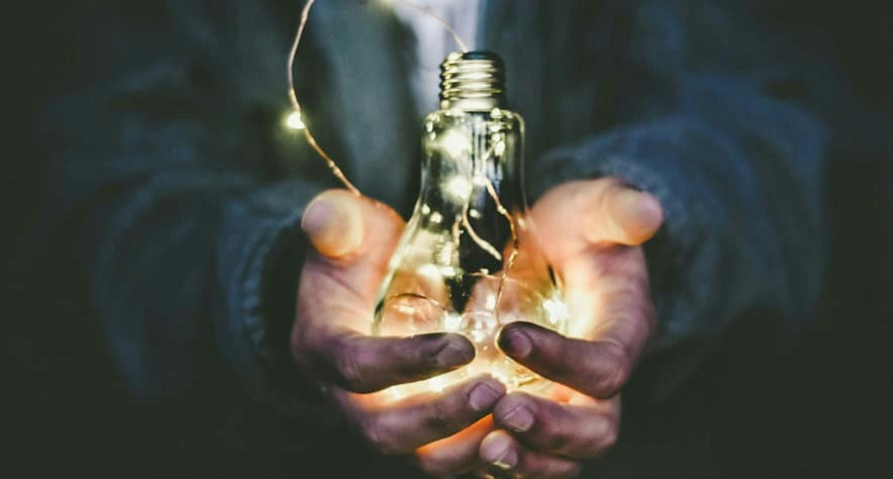 person holding a lightbulb