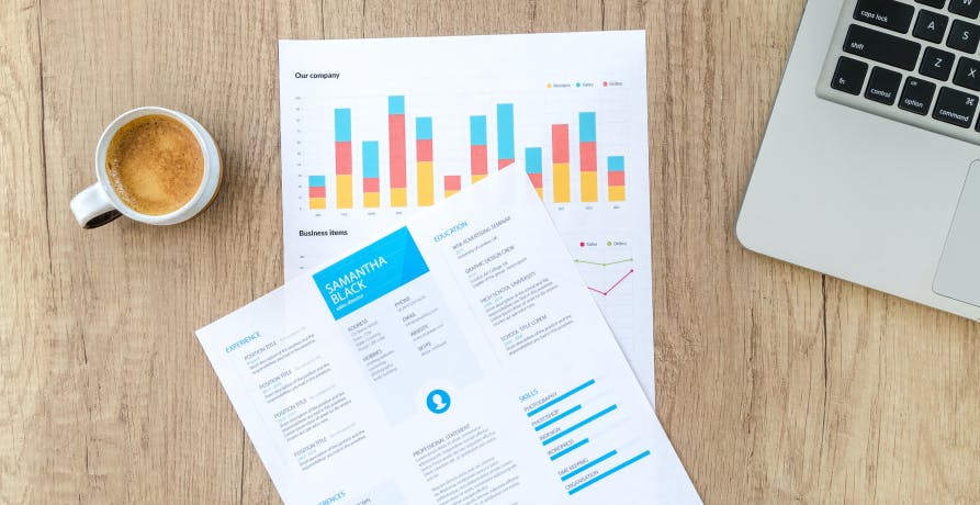 data charts with coffee on left and laptop on right