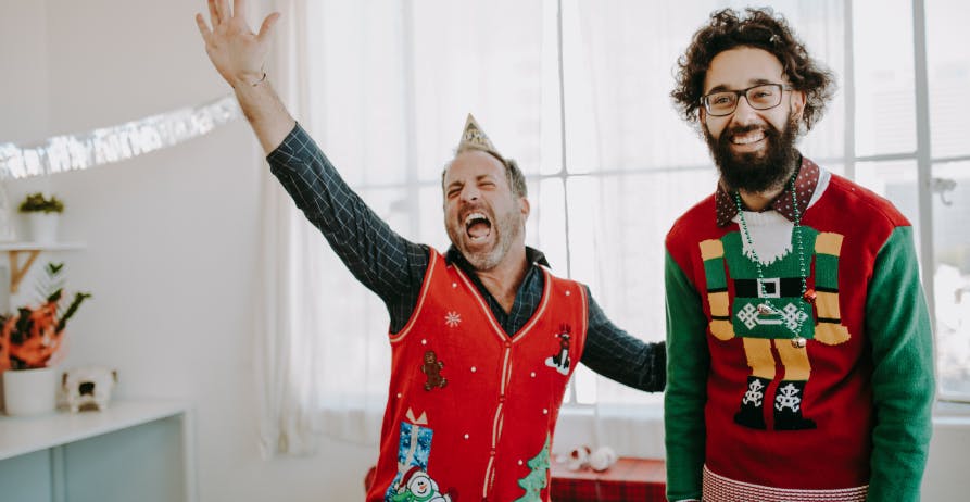 happy employees with Christmas sweaters
