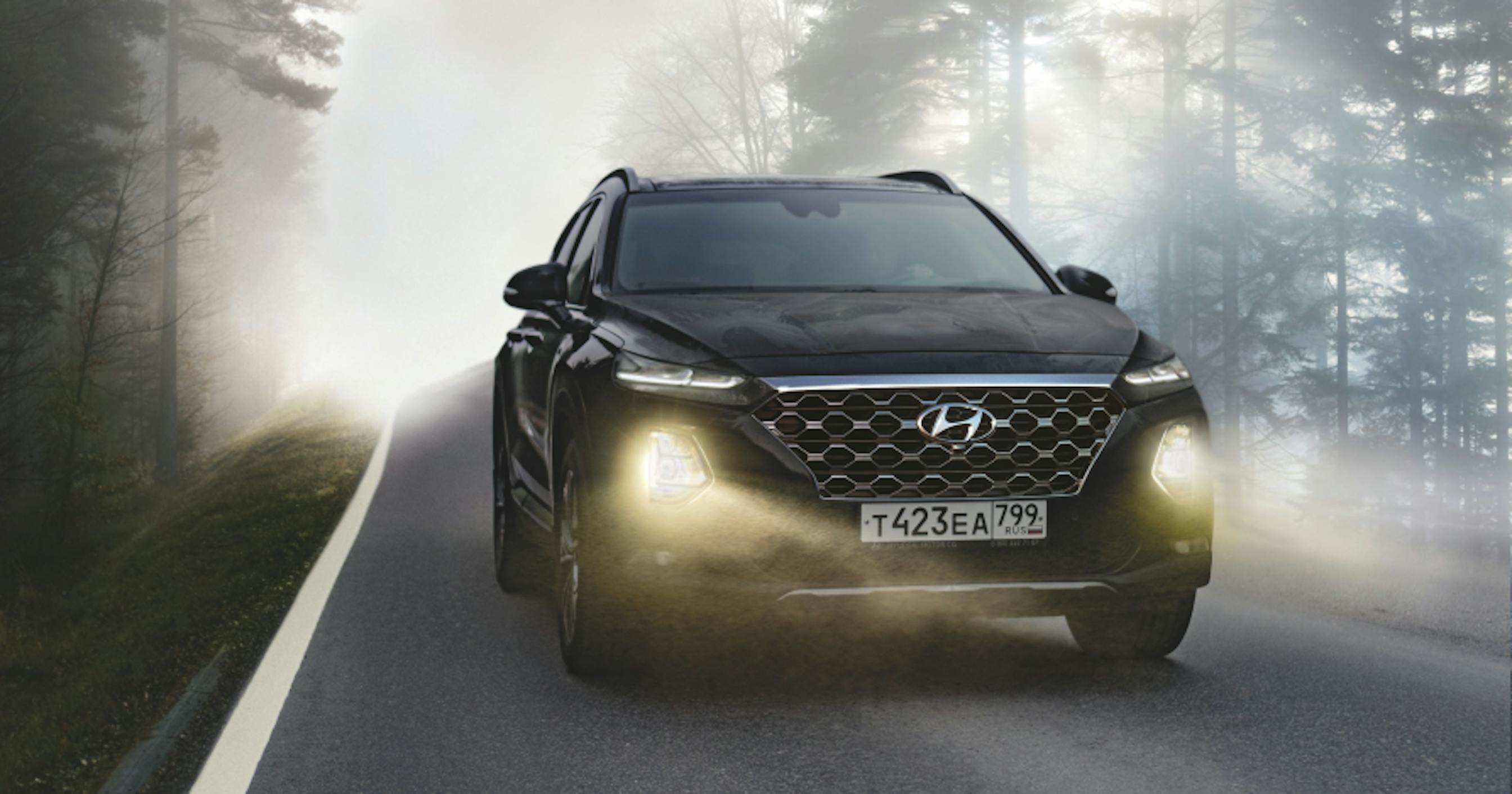 black suv driving on street with headlights