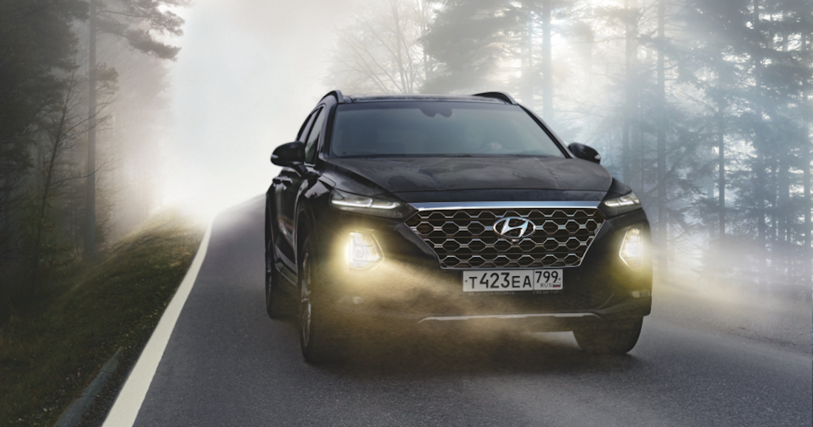 black suv driving on street with headlights