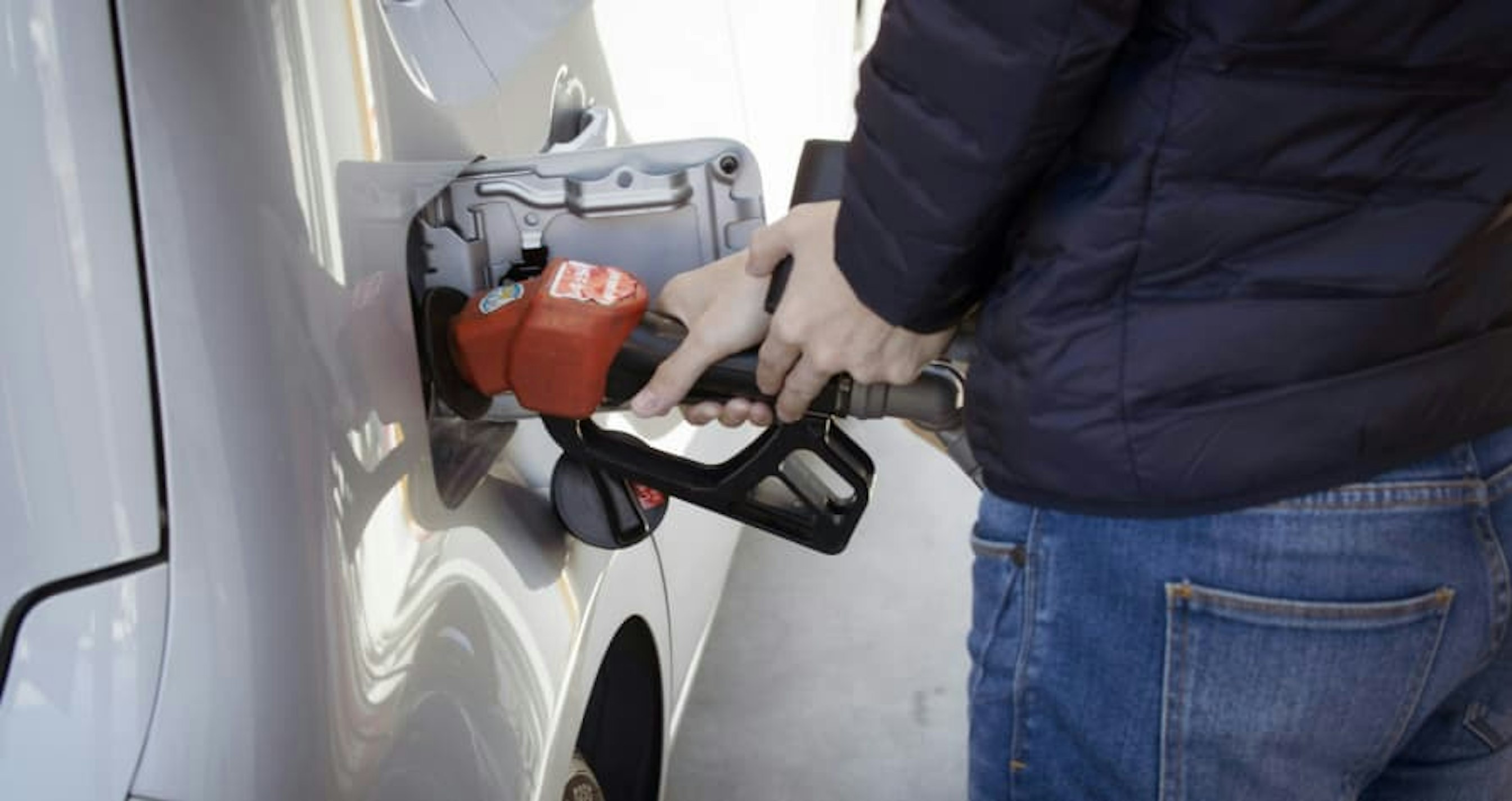 person pumping gas
