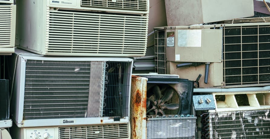 air conditioning units piled on top of one another