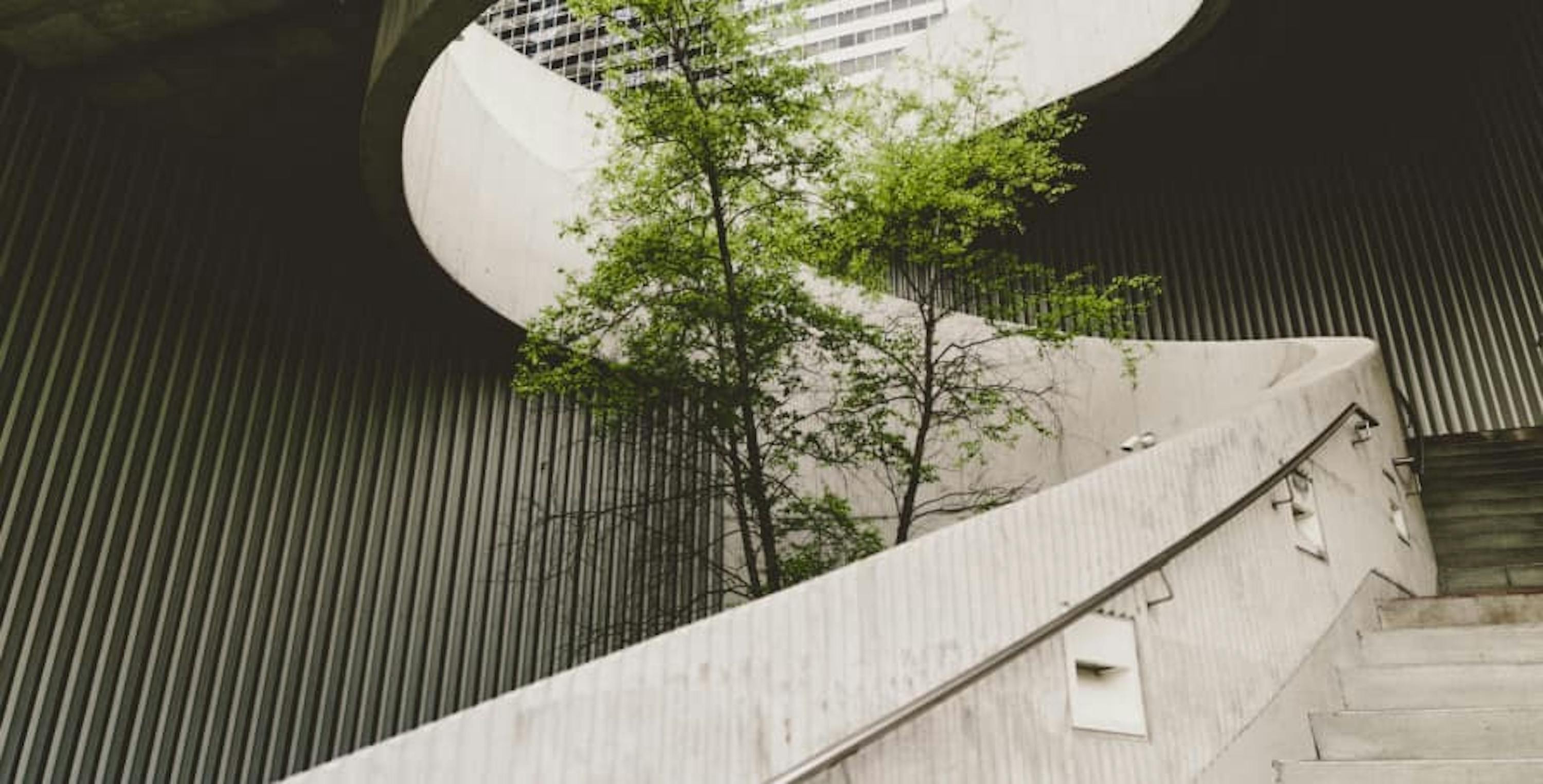 spiral staircase outdoors with small green trees