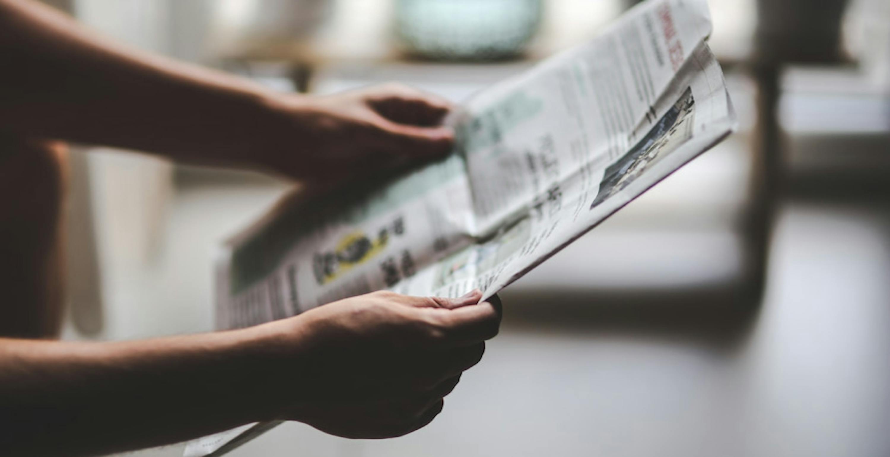 someone holding a newspaper