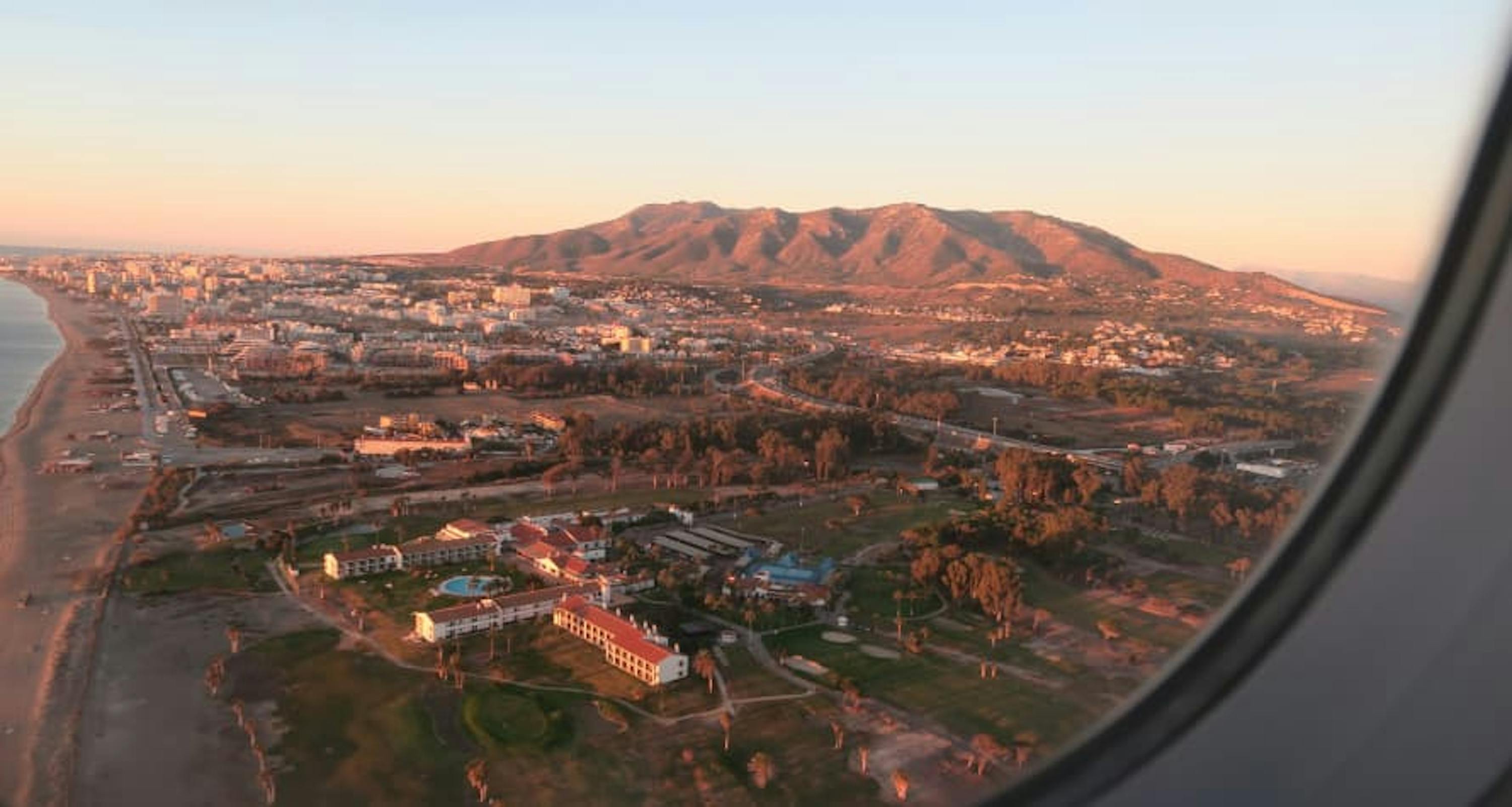 view of malaga spain from airplane window at sunrise