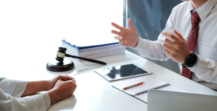 people discussing at desk with a gavel