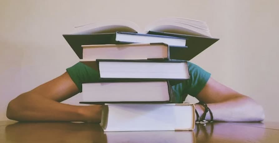 a person sitting behind books