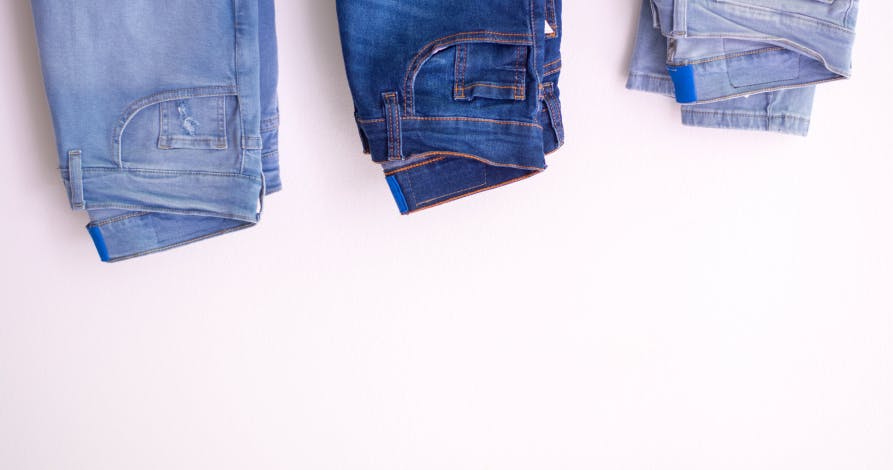 jeans in different colors on top of photo
