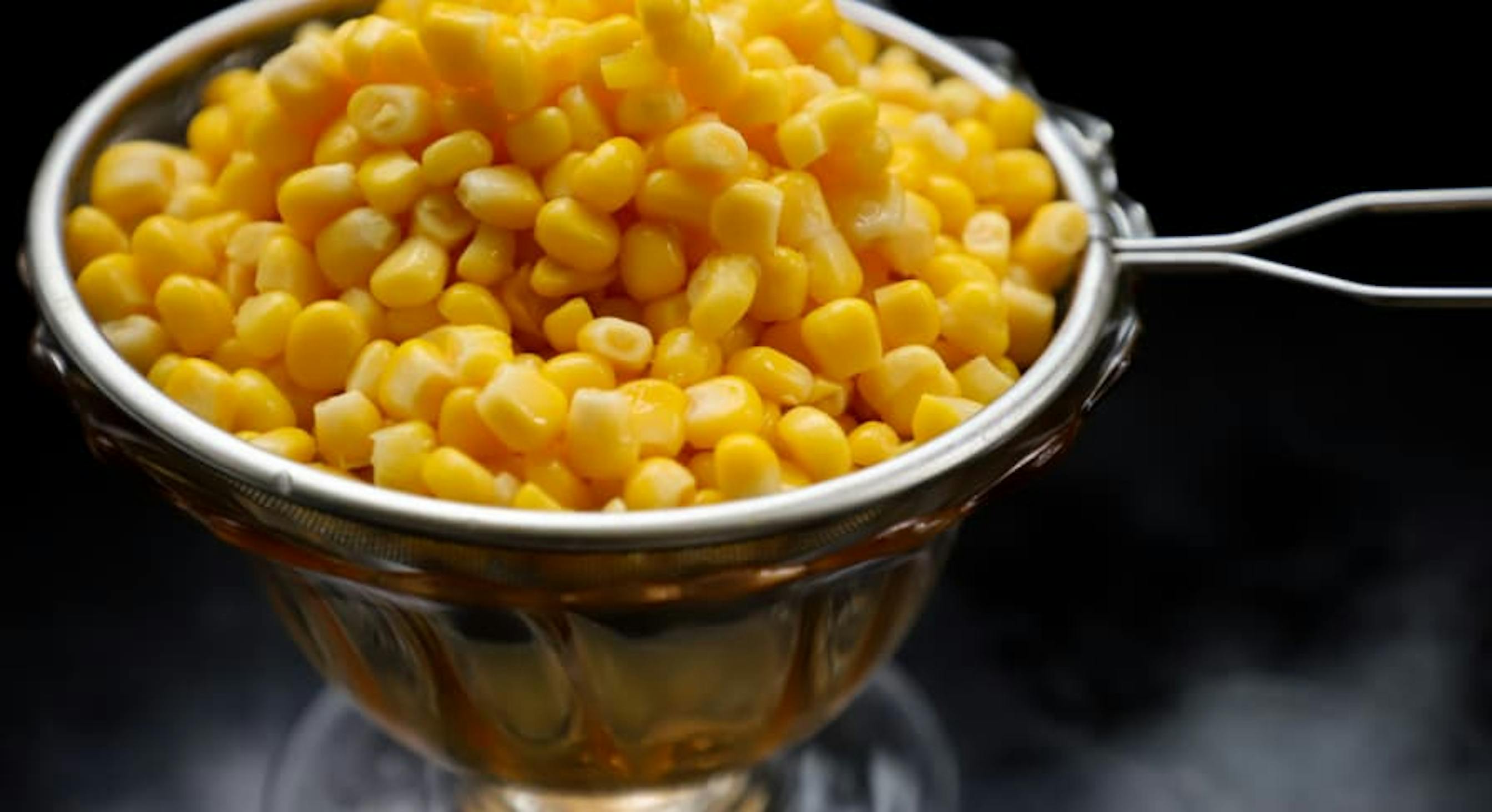 canned corn in a measuring cup